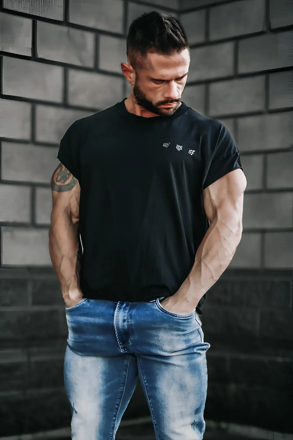 Black oversized raw-cut cropped tee with short sleeves and subtle white logo detail on the chest