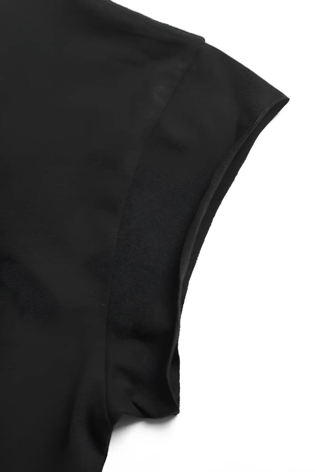 Black oversized raw cut cropped tee sleeve made from smooth slightly glossy fabric