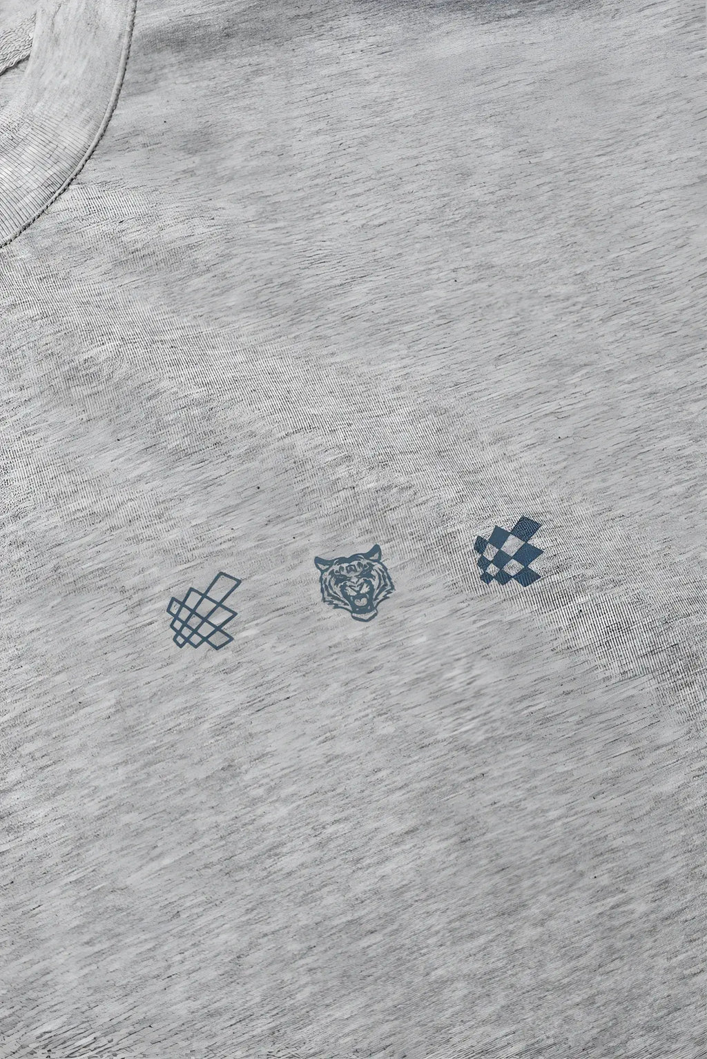 Oversized raw-cut cropped tee in heather gray cotton with navy blue graphic of knot tiger head and checkered pattern