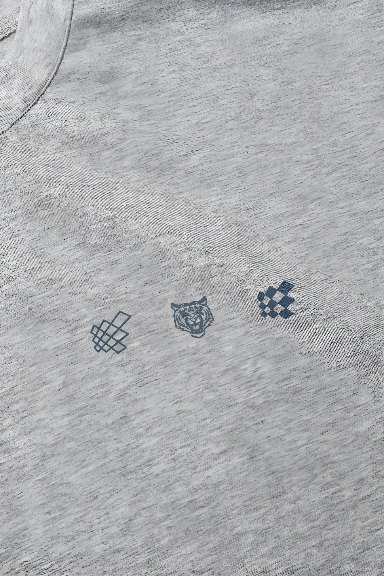 Oversized raw-cut cropped tee in heather gray cotton with navy blue graphic of knot tiger head and checkered pattern