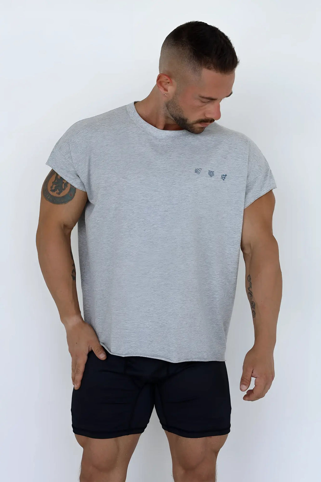Gray heathered cotton oversized raw cut cropped tee with a small embroidered logo on the left chest