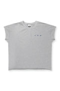 A heather gray oversized raw-cut cropped tee with short sleeves and a subtle embroidered logo on the chest