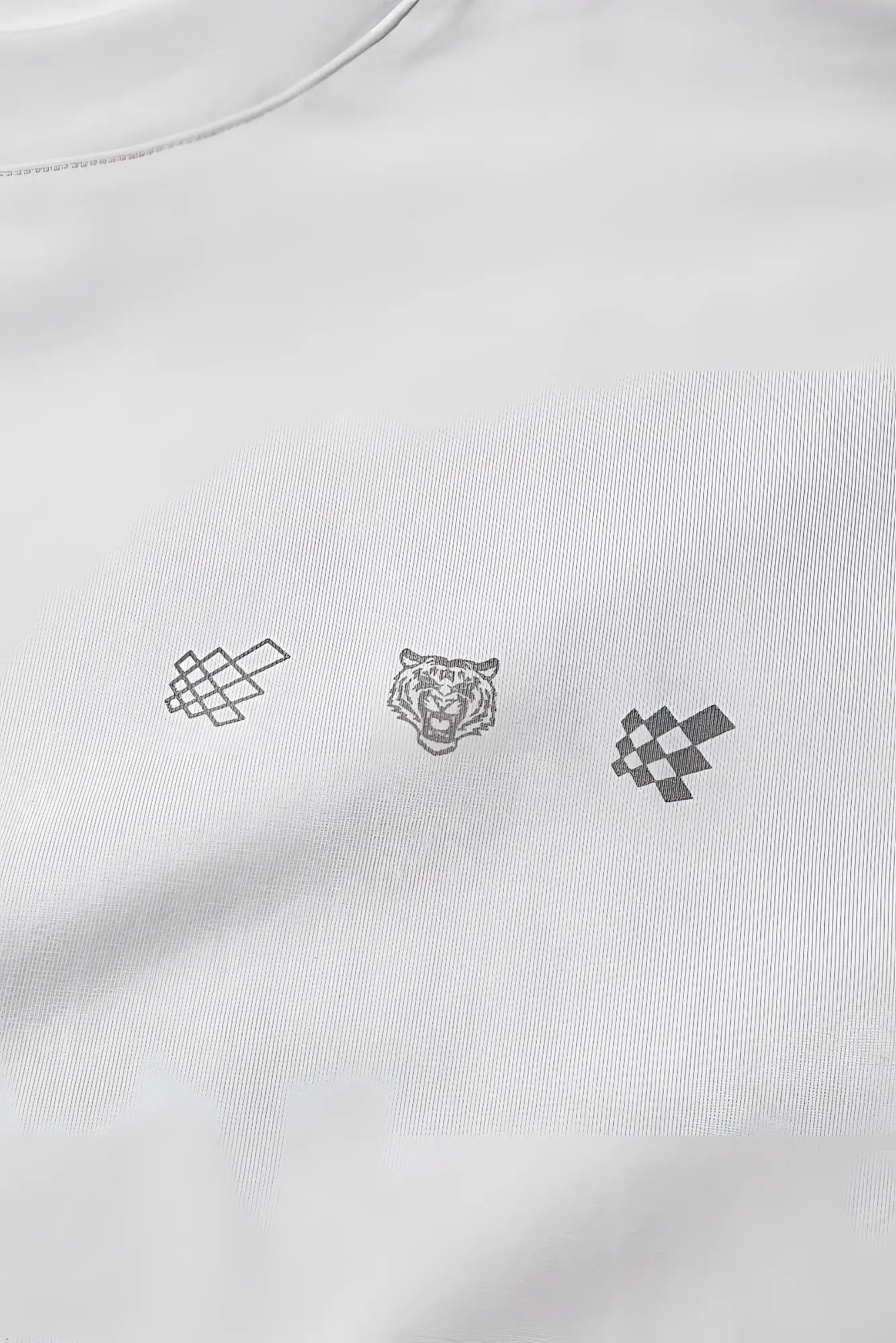 White oversized raw-cut cropped cotton tee with three minimalist embroidered logos of a knot, tiger head, and checkered flag