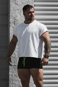 White oversized raw-cut cropped tee with short sleeves and subtle embroidered logo on the chest in soft cotton