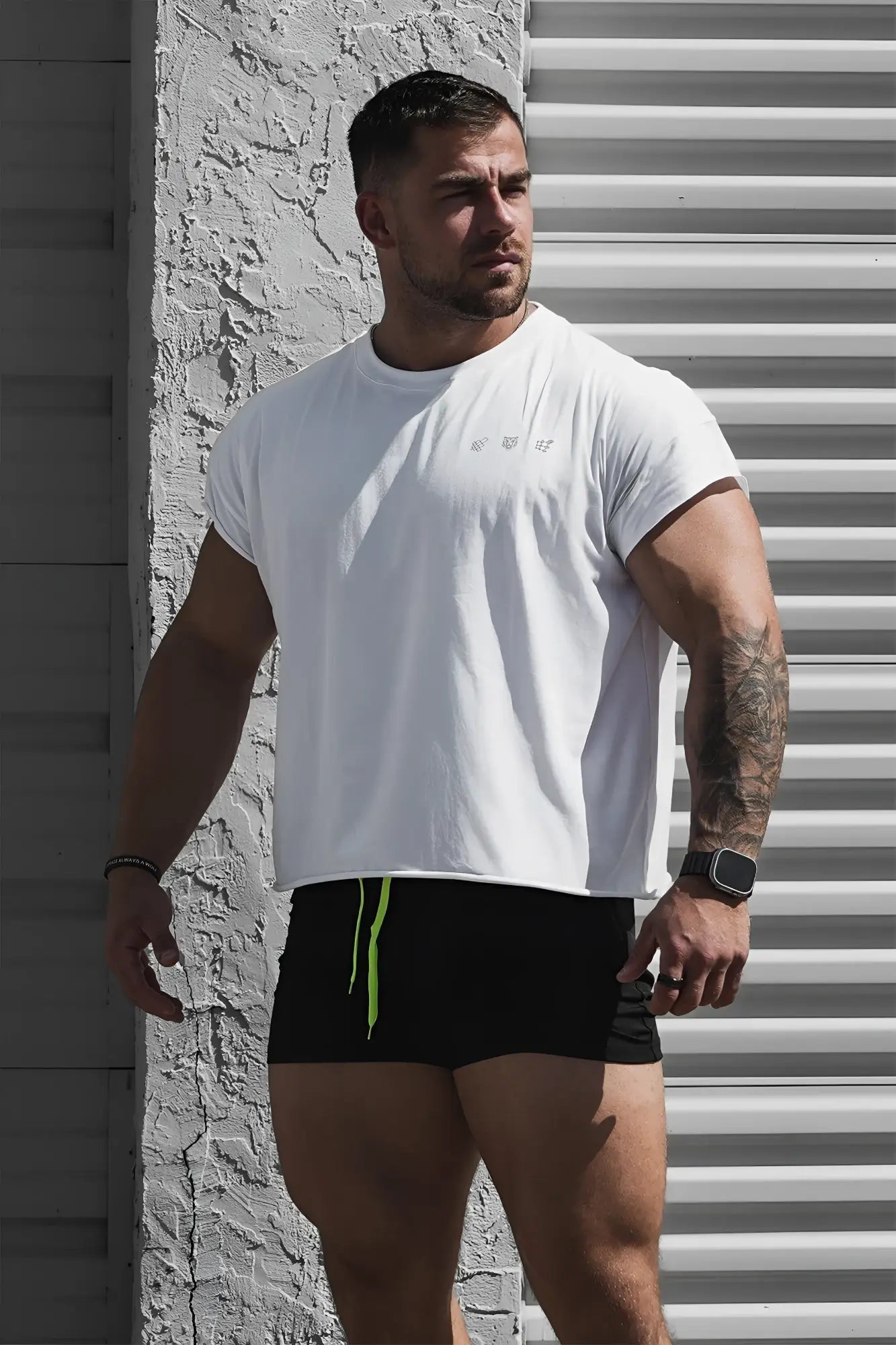 White oversized raw-cut cropped tee with short sleeves and subtle embroidered logo on the chest in soft cotton