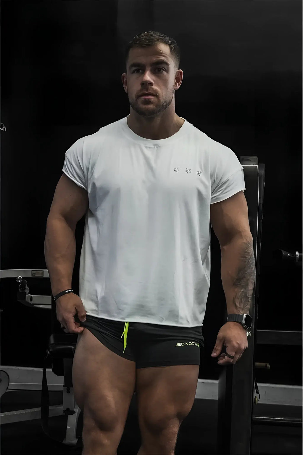 White oversized raw-cut cropped tee with short sleeves and subtle chest logo perfect for casual wear