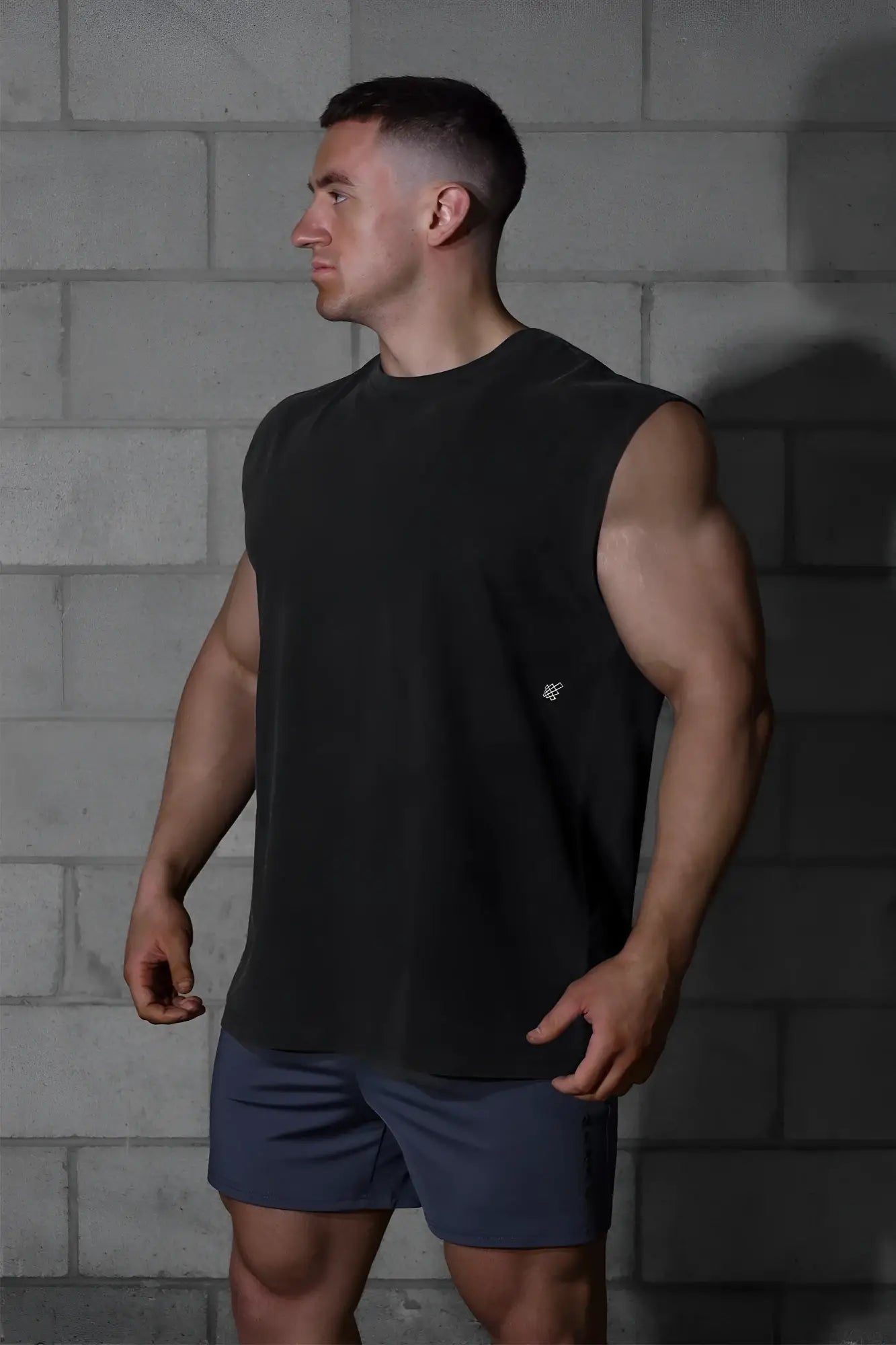 Black sleeveless muscle tee with small white logo on left chest oversized washed cotton jed north shirt