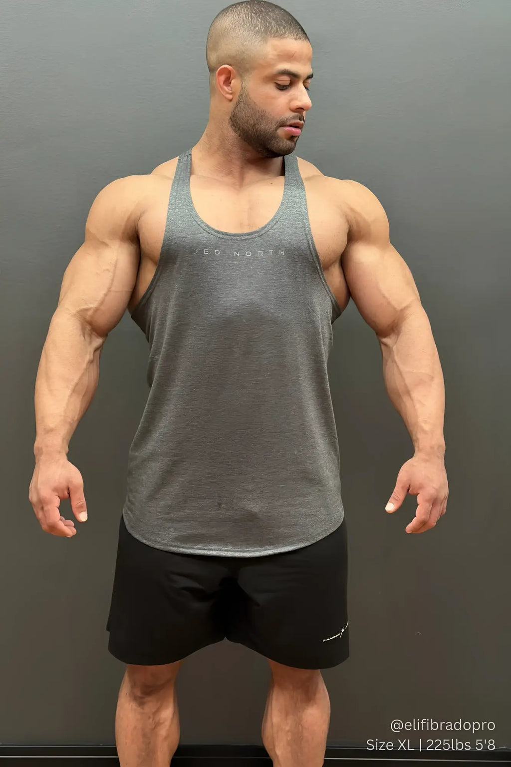 Gray heathered tank top with subtle white logo across chest paired with black jed north performance air-tech shorts
