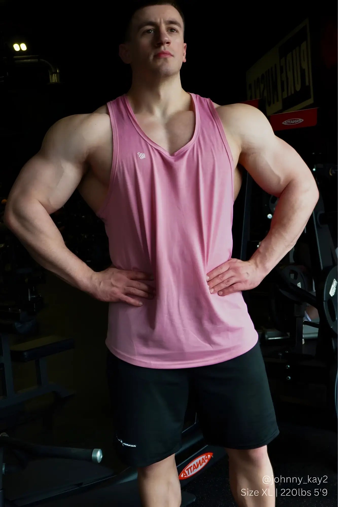 Pink athletic tank top with v-neck and small logo on left chest paired with jed north performance air-tech black shorts