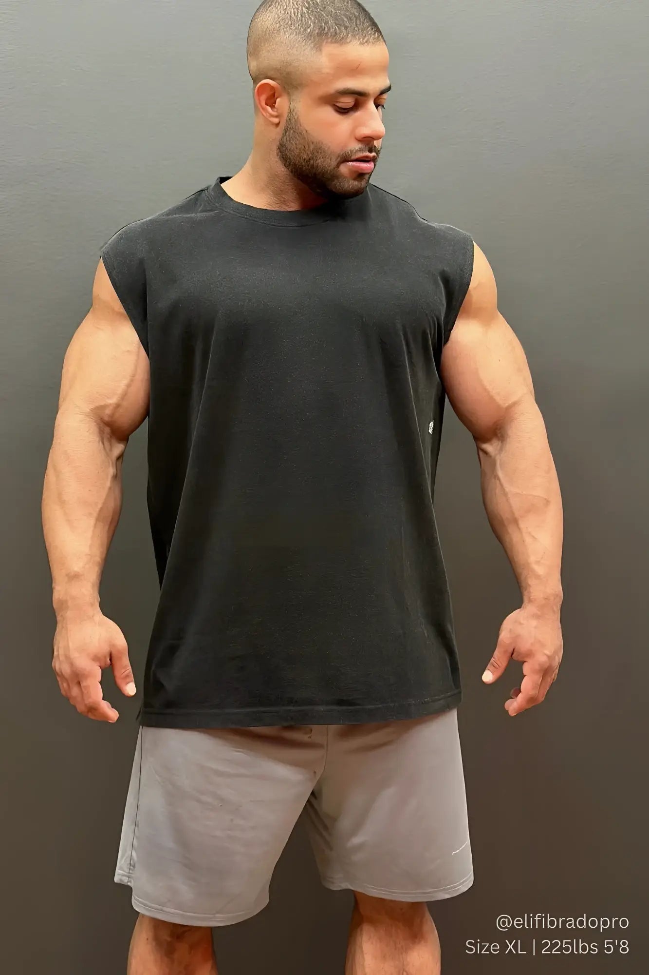 Black sleeveless t-shirt with a simple crew neck design paired with jed north gray performance air-tech athletic shorts