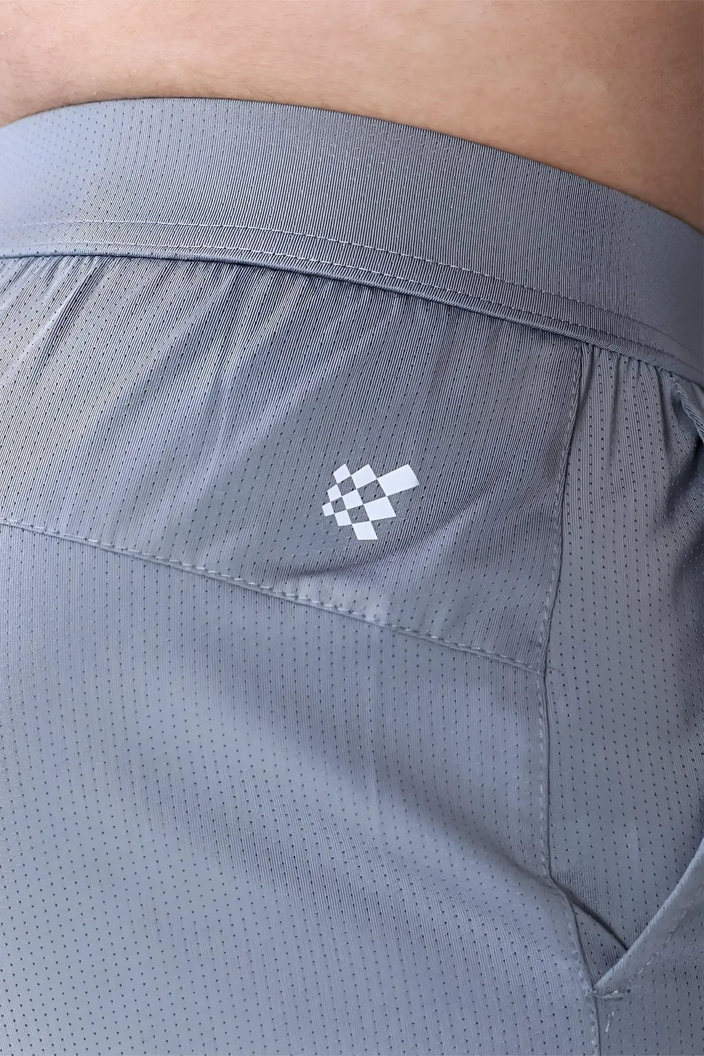 Gray jed north performance air-tech athletic shorts with subtle perforated texture and white checkered logo on side seam