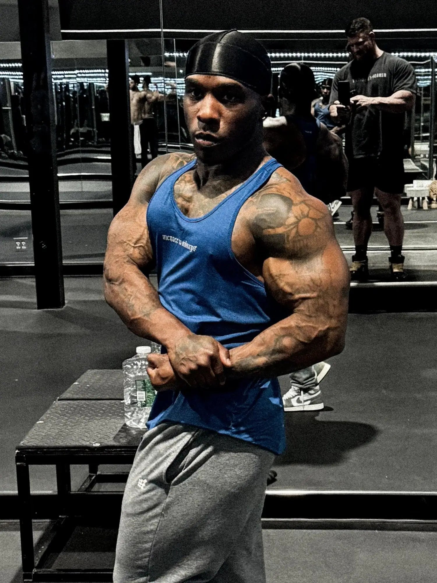 Blue jed north performance max bodybuilding stringer tank top with white lettering and black headband in denim blue