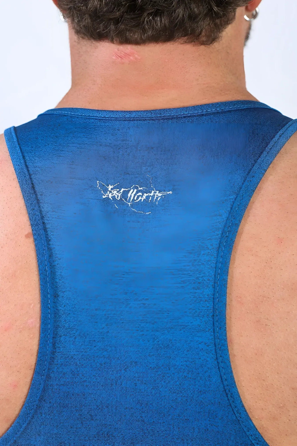 Back view of jed north performance max bodybuilding stringer in denim blue with white embroidered logo on upper back