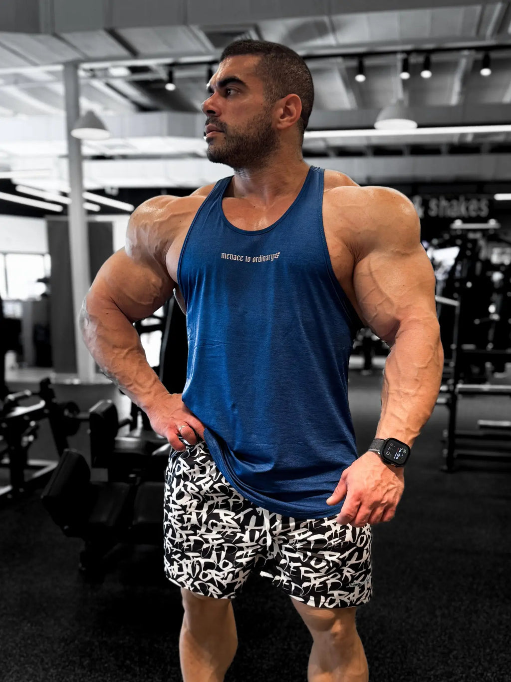 Blue muscle tank top with white text across the chest made of breathable fabric for bodybuilding by Jed North