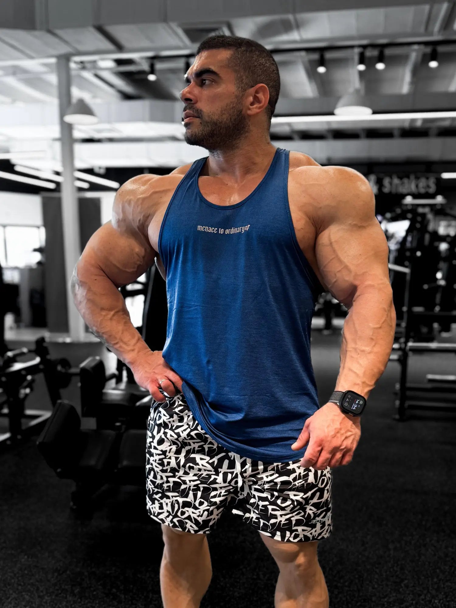 Blue muscle tank top with white text across the chest made of breathable fabric for bodybuilding by Jed North