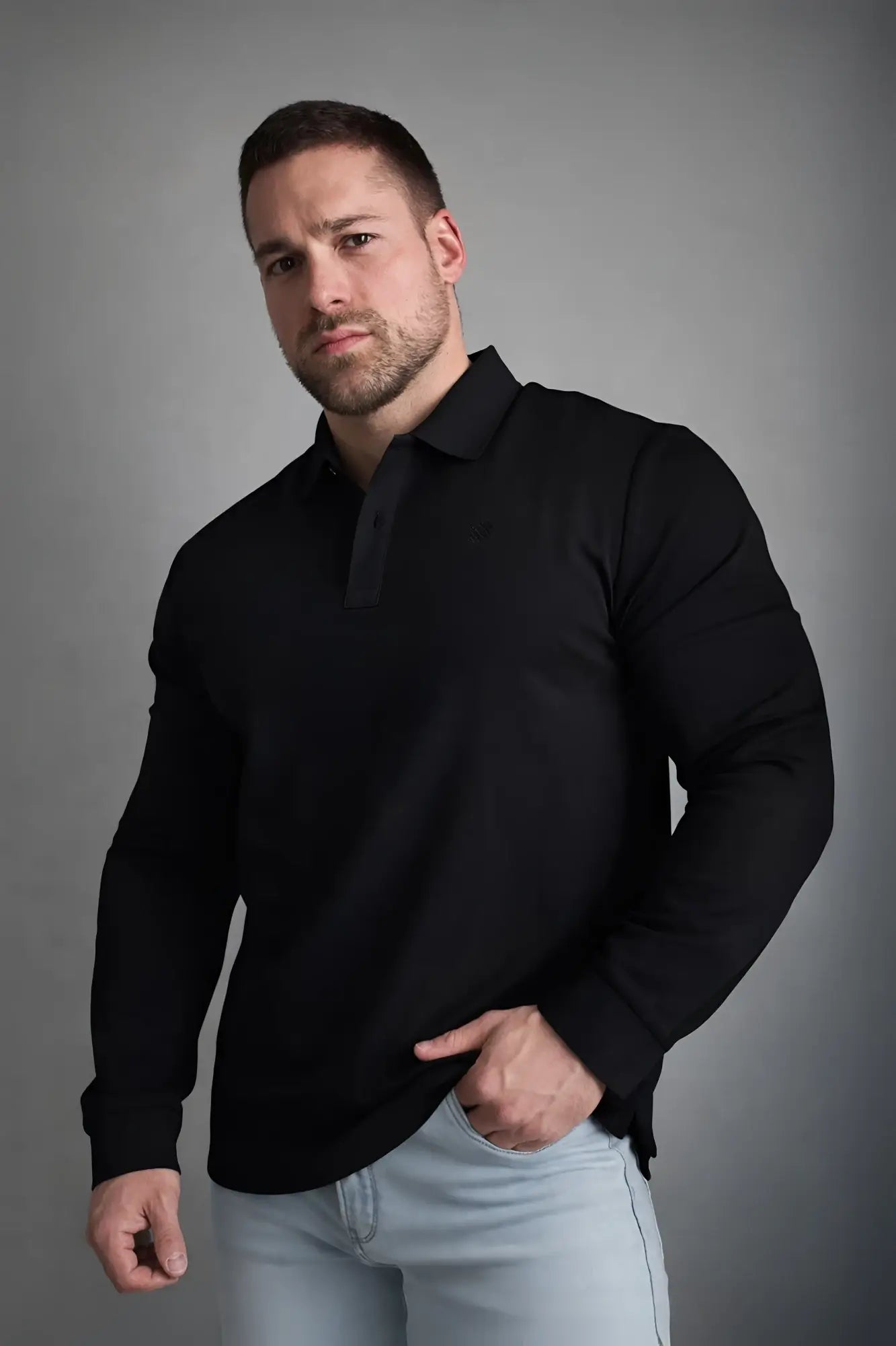 Black long-sleeved polo button-up shirt with classic collar and subtle ribbed placket for casual or formal wear