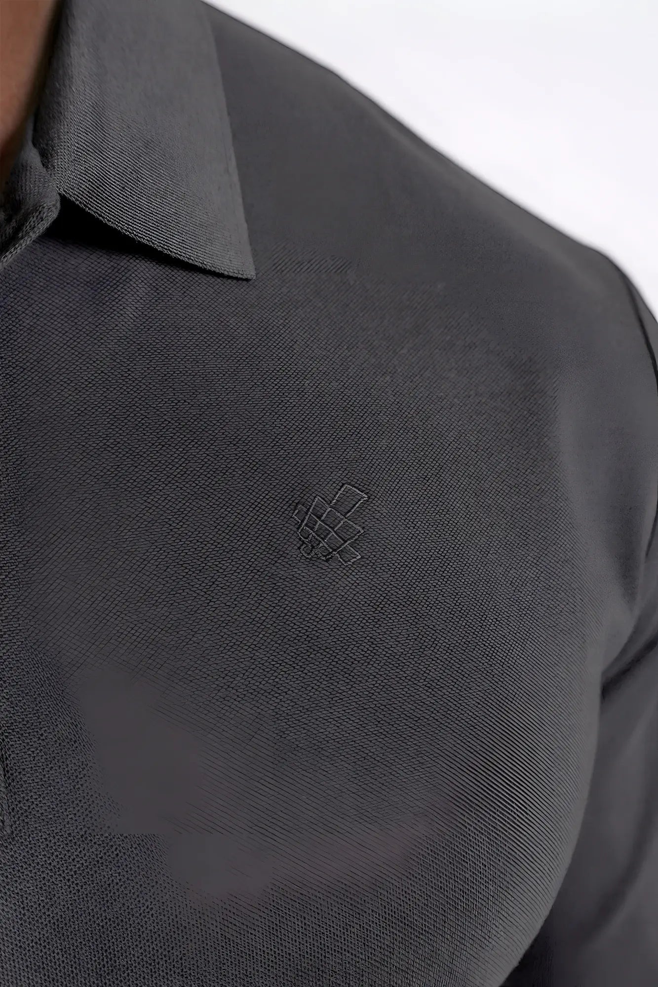 Dark gray polo button-up longsleeve with subtle textured weave and small embroidered logo on the chest