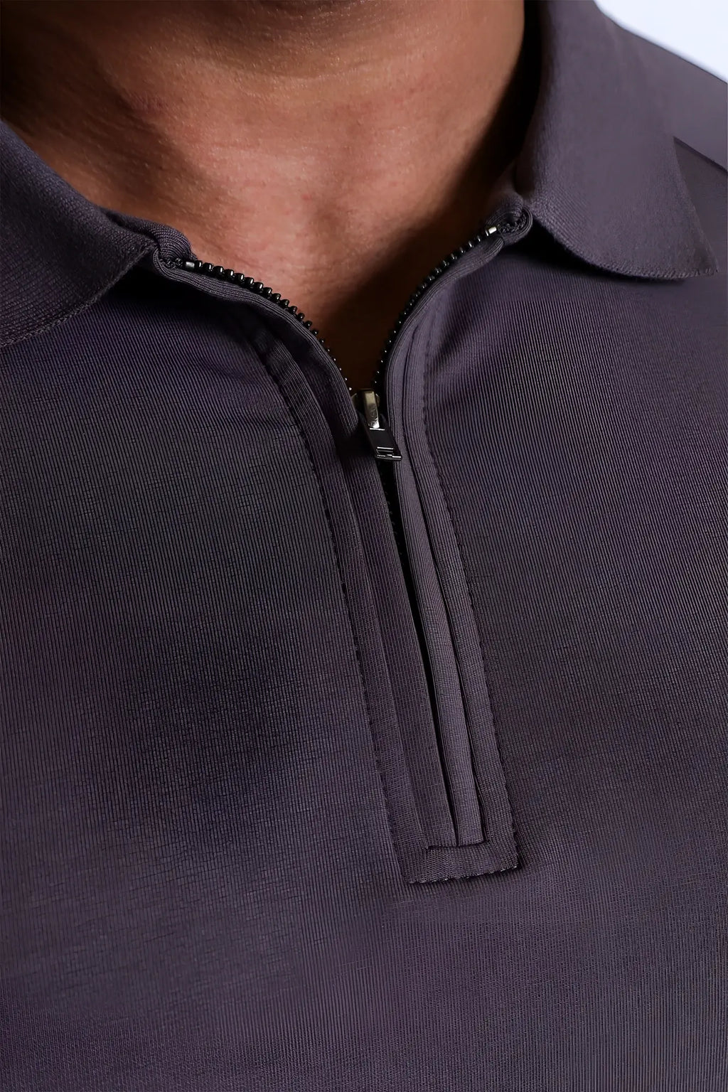 Premium muscle-fit polo tee with half-zip in dark gray featuring sleek ribbed knit fabric and black zipper pull