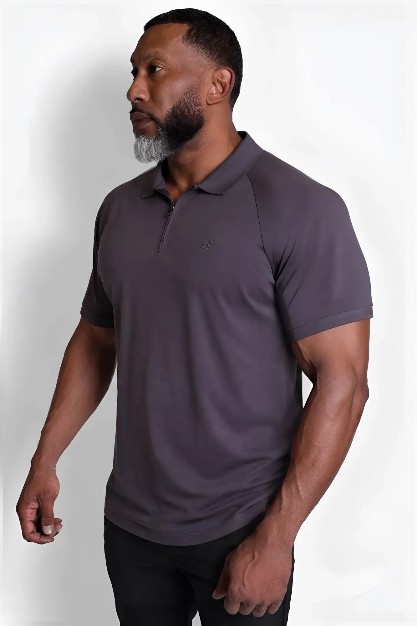 Dark gray premium muscle-fit polo tee with zipper and subtle logo on the chest designed for performance wear