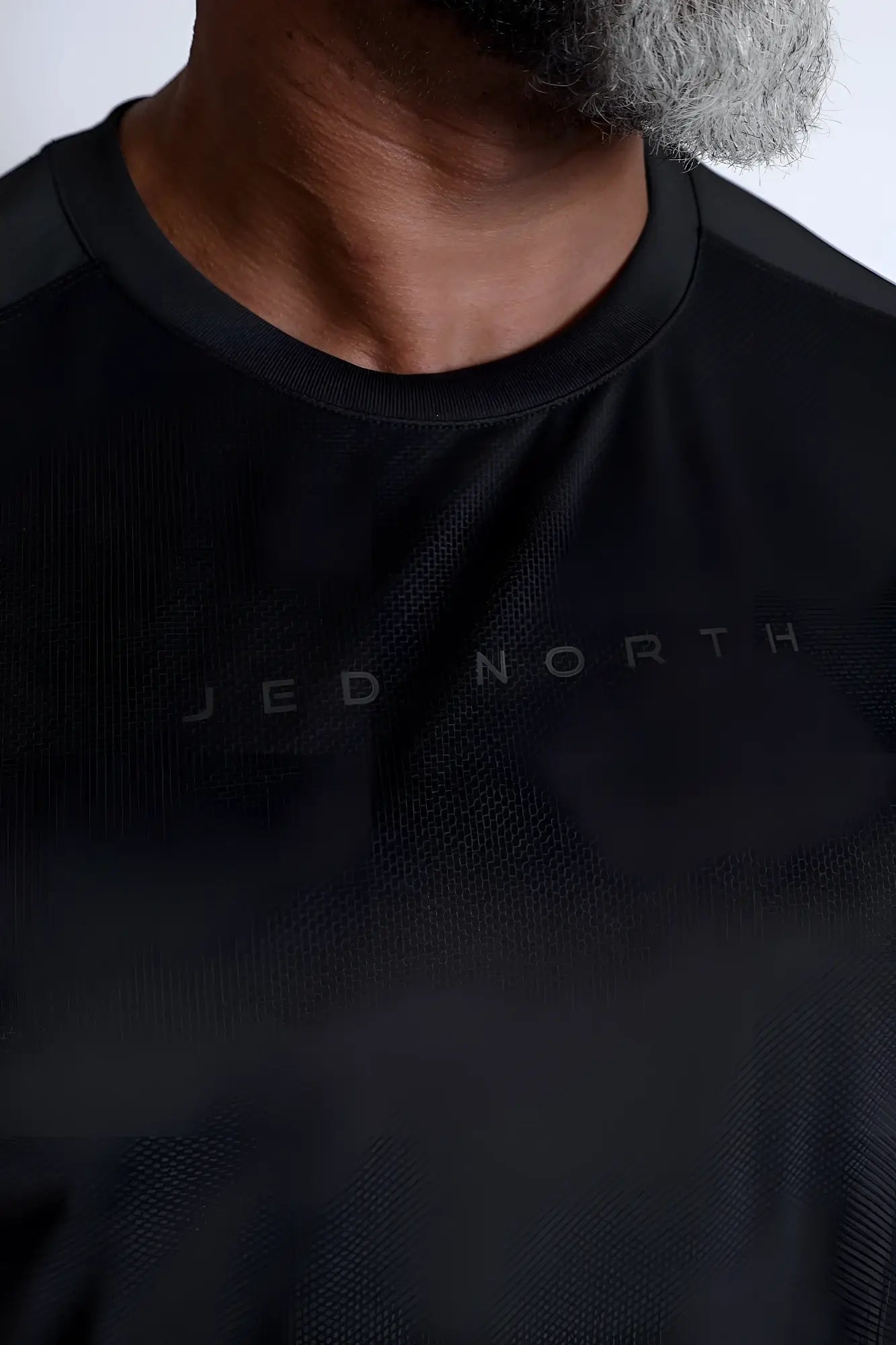 Black premium training tee with subtle jed north branding across the chest designed for athletic performance