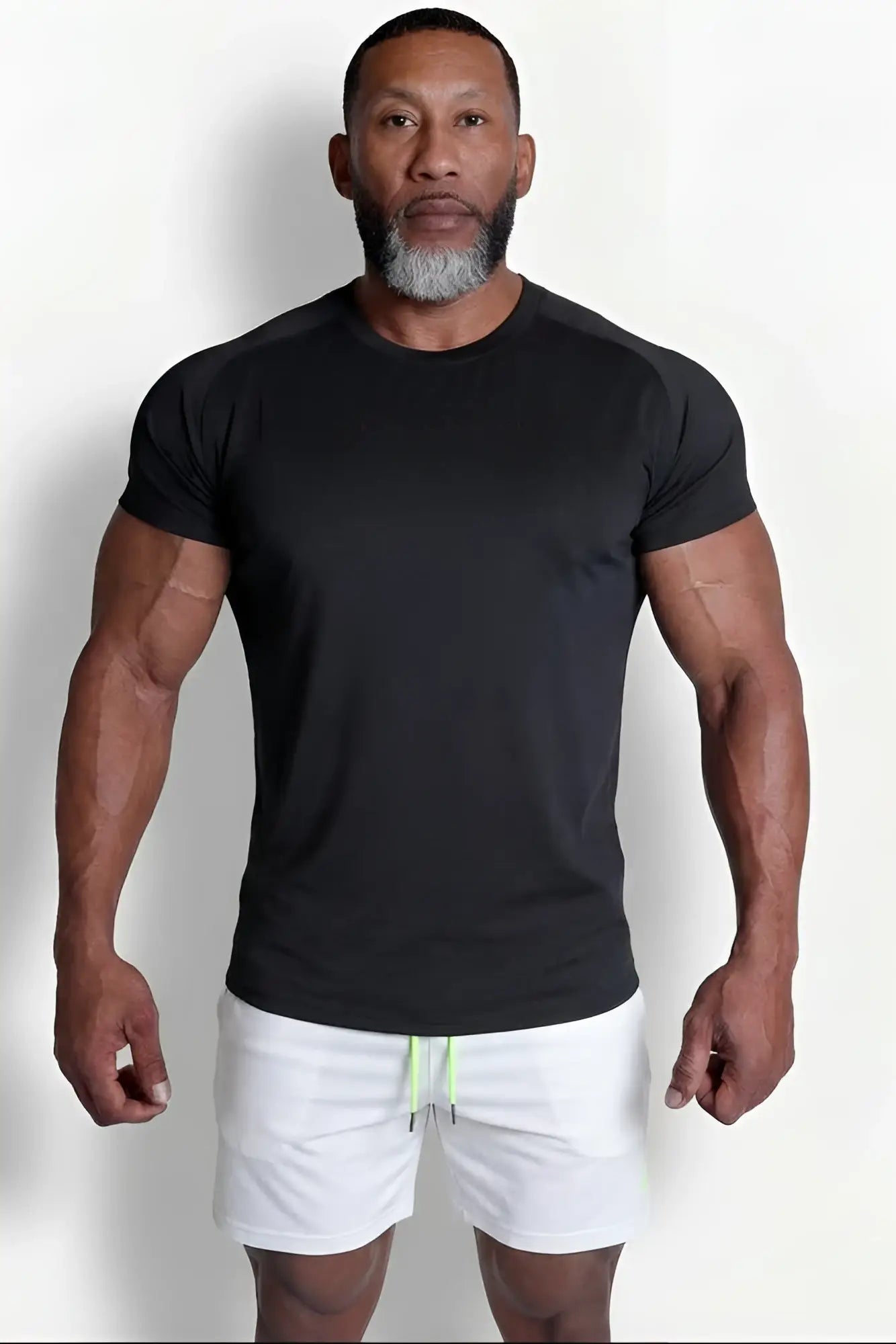 Premium training tee black short-sleeved athletic t-shirt with crew neck and subtle side panels for workouts
