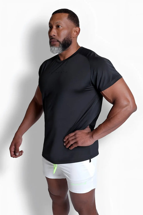 Black premium training tee with subtle ribbed texture and neon green trim at waistband for athletic use