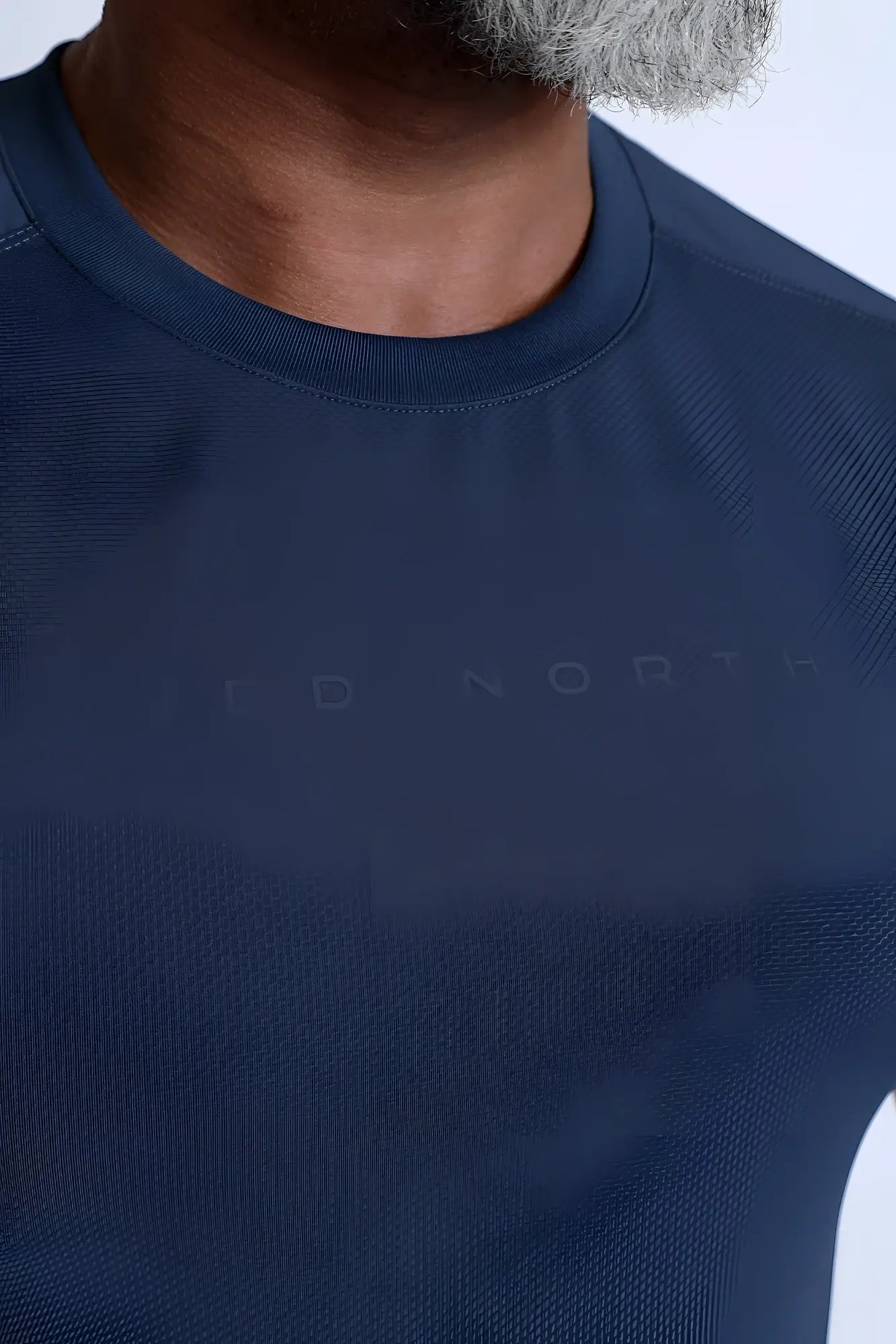 Premium training tee navy made of dark navy blue textured performance fabric with subtle jed north branding on chest