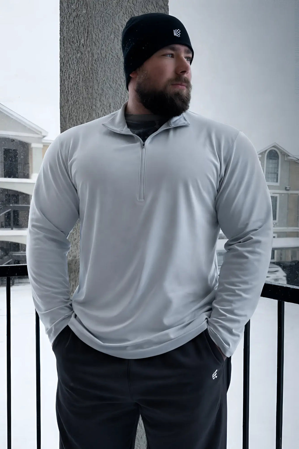 Heather gray quarter-zip training long sleeve shirt with subtle textured fabric and small chest logo for athletic use
