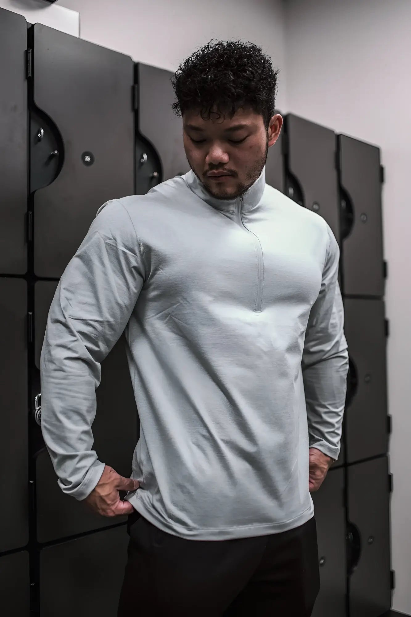 Light gray heather gray quarter-zip training long sleeve athletic top with a half-zip collar and long sleeves