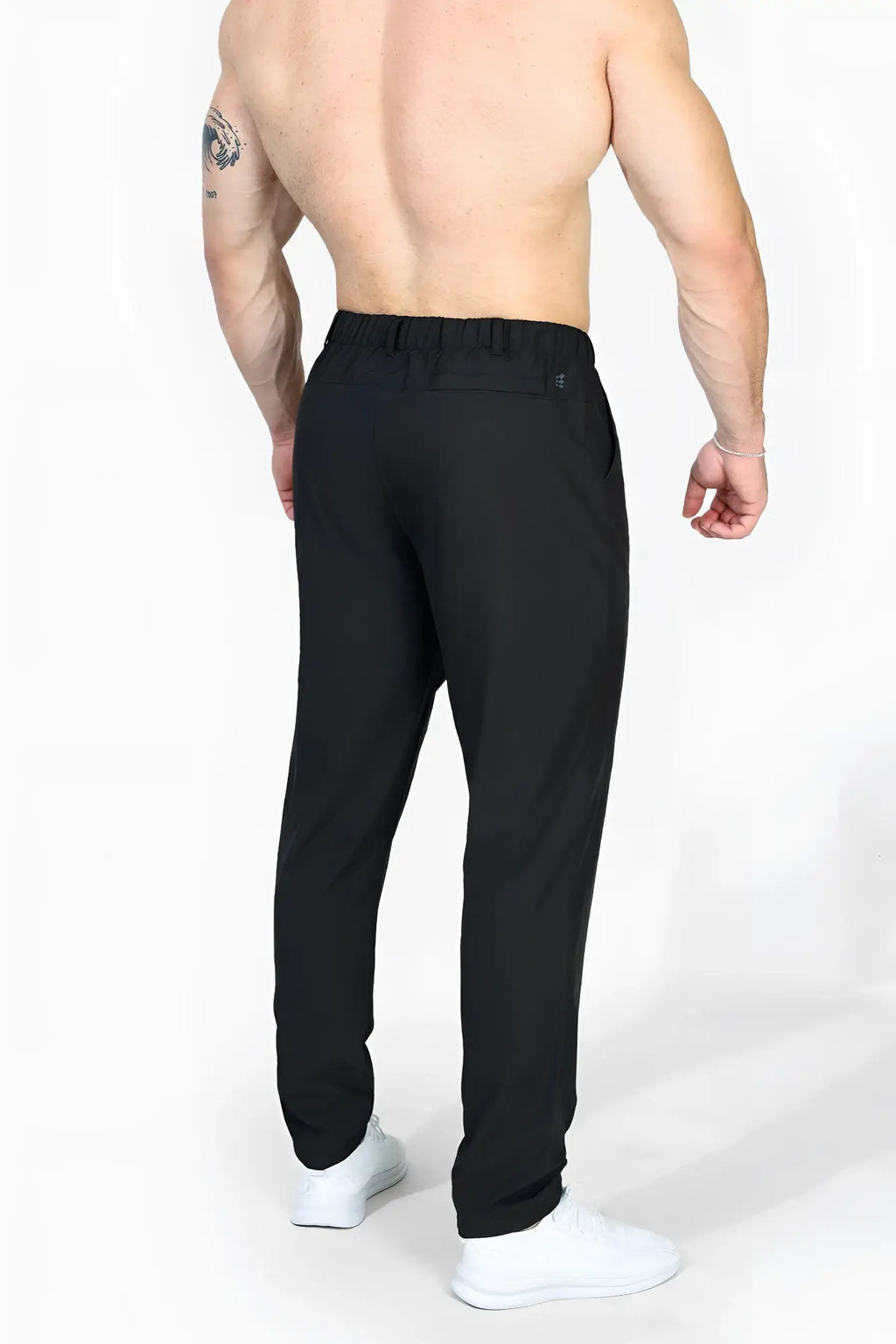 Jed north quick-dry tech pants black showing back side with elastic waistband and subtle logo on back pocket