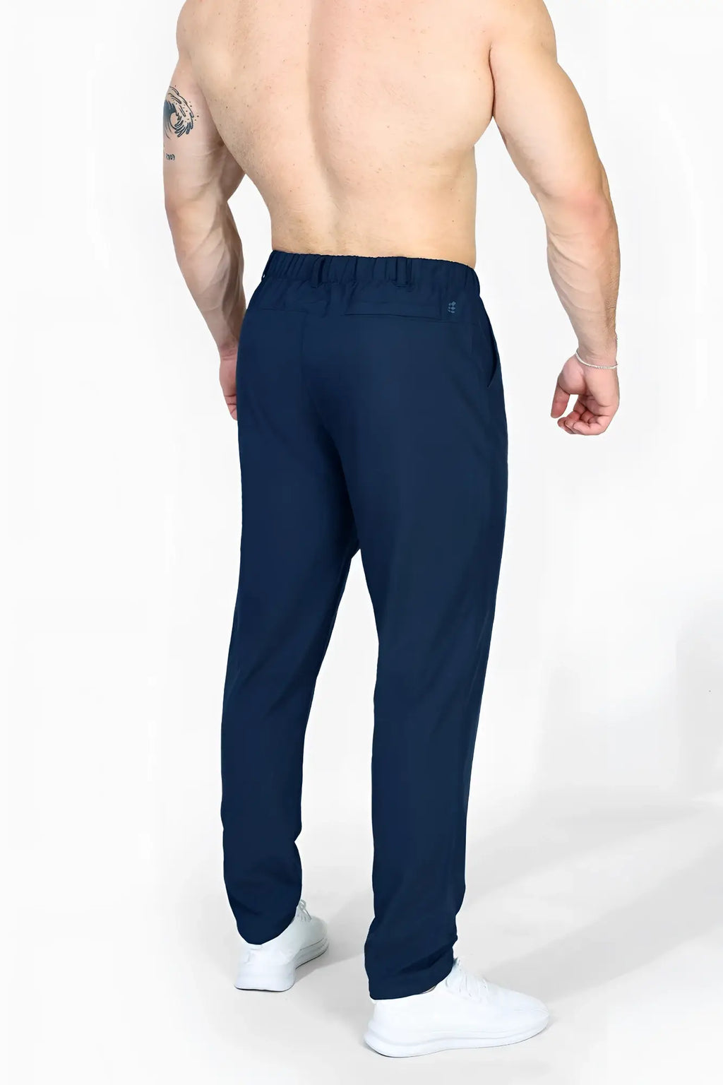 Navy blue Jed North quick-dry tech pants with elastic waist and subtle side seam detailing in sleek modern cut