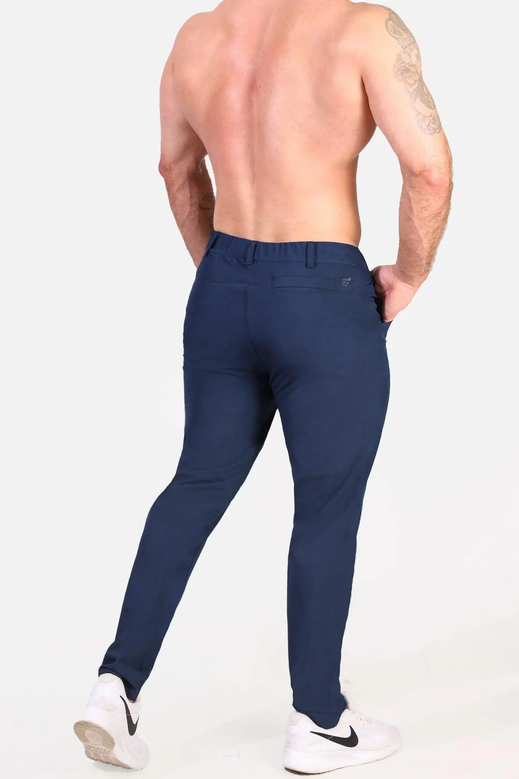 Back view of jed north quick-dry tech pants navy slim-fit textured fabric with small brand logo on waistband