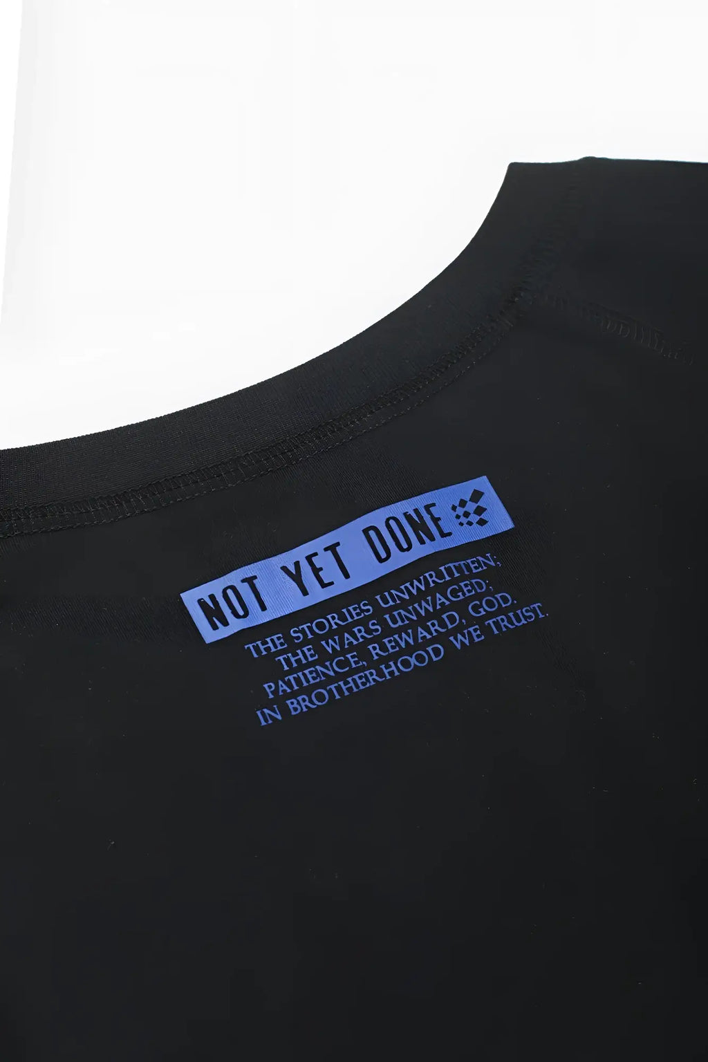 Black cotton raglan sleeveless muscle tank with blue rectangular label and not yet done text on the front