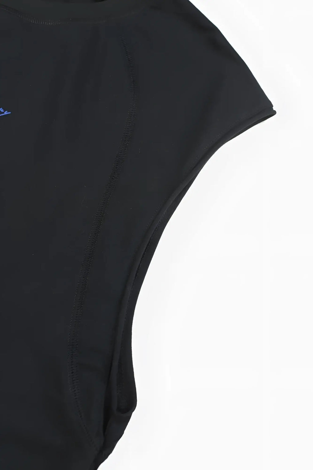 Black raglan sleeveless muscle tank with subtle blue embroidery on the shoulder in a soft breathable fabric