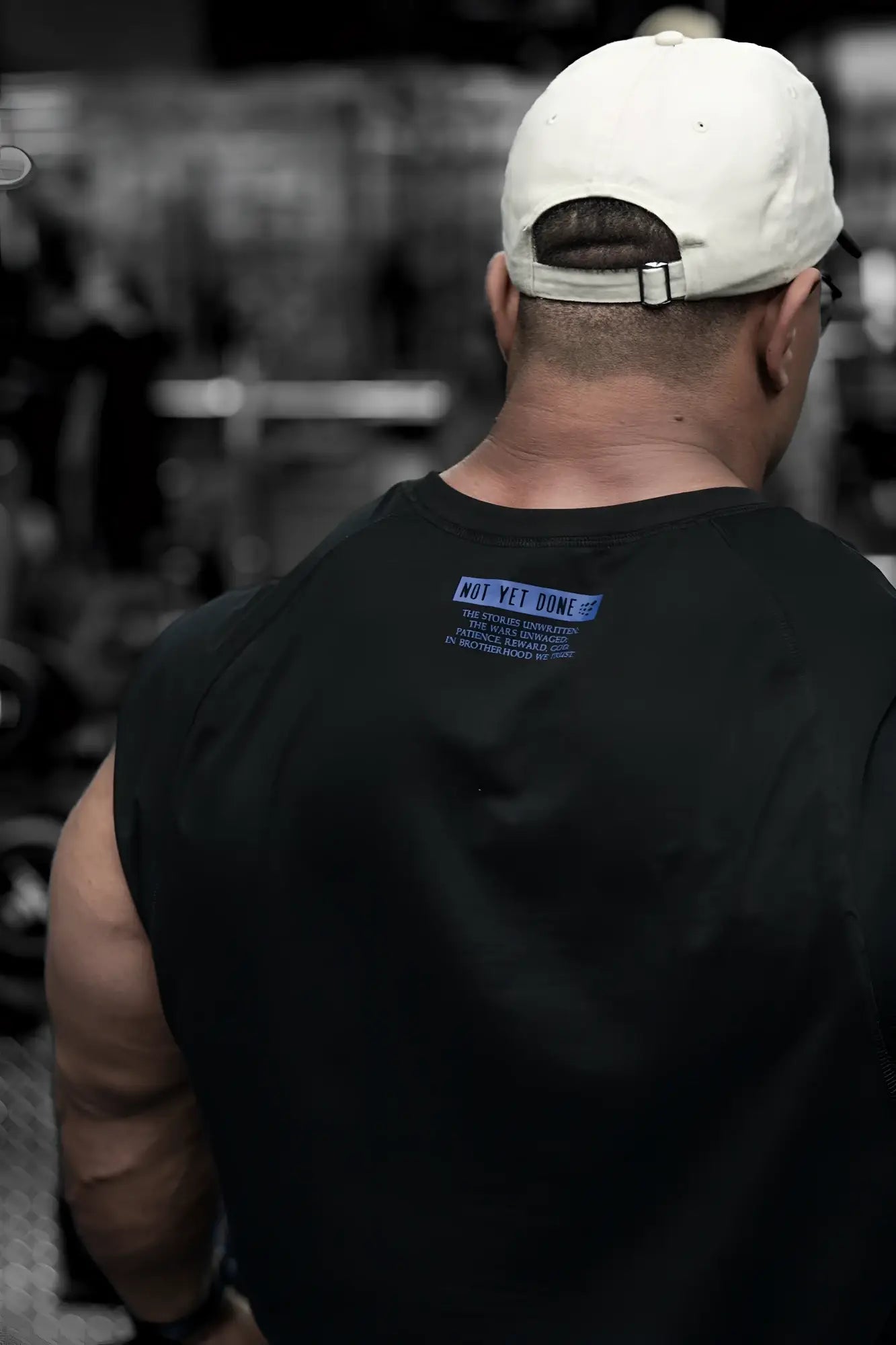 Black raglan sleeveless muscle tank back showing blue not yet done graphic on black sleeveless t-shirt material