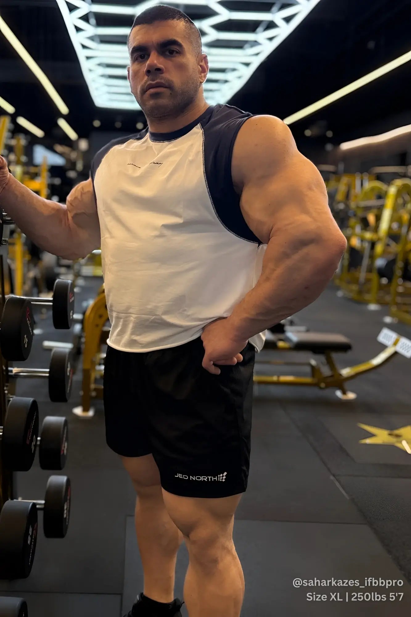 Black athletic shorts with jrd north branding on the left leg paired with raglan sleeveless tank top white and navy