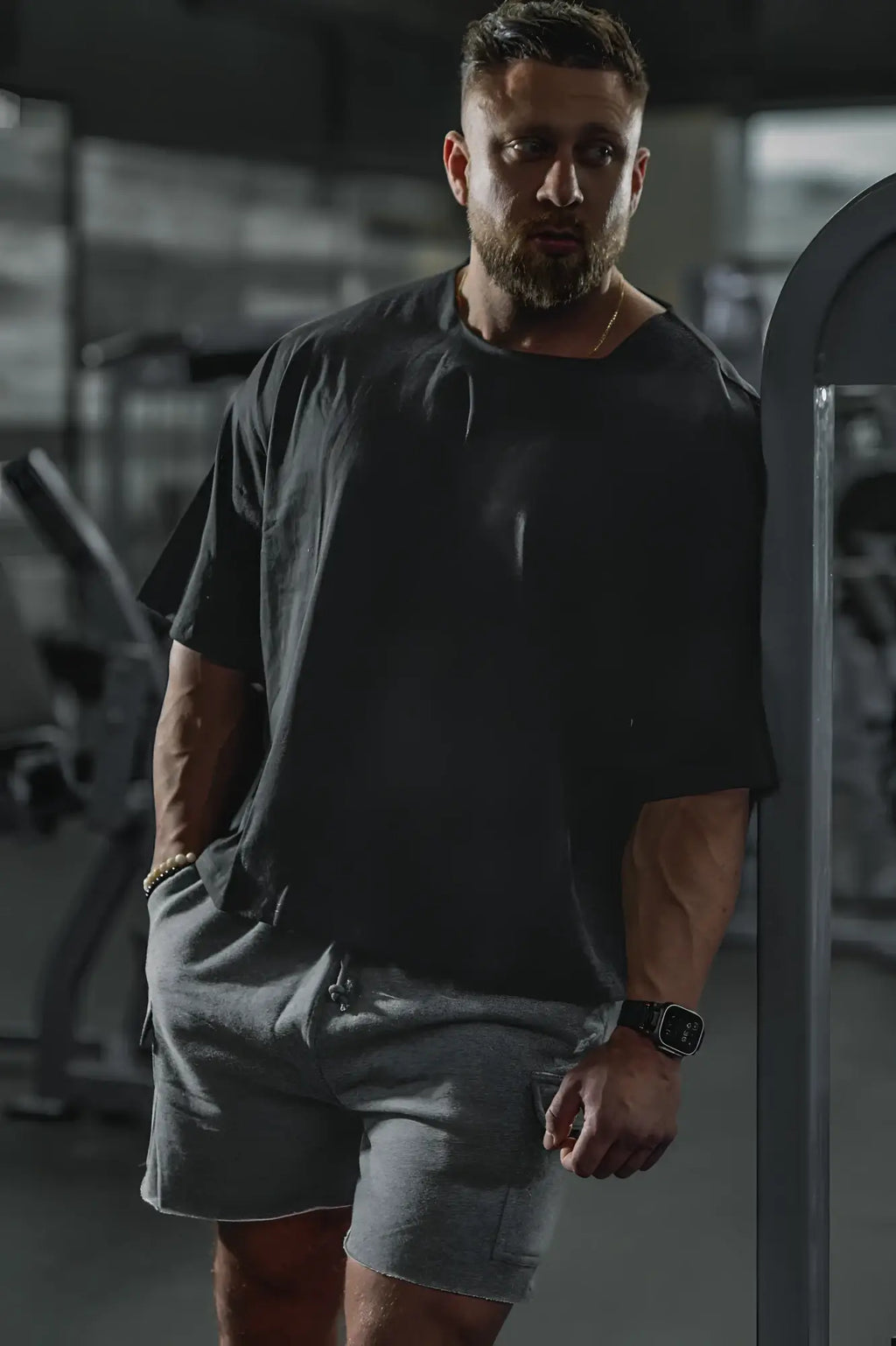 Black raw-cut boxy crop tee with oversized relaxed fit and slightly wrinkled texture in soft cotton fabric