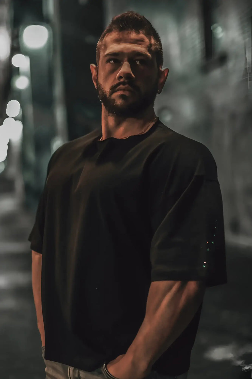 Black raw-cut boxy crop tee with short sleeves and subtle textured detailing on sleeve made from soft cotton blend