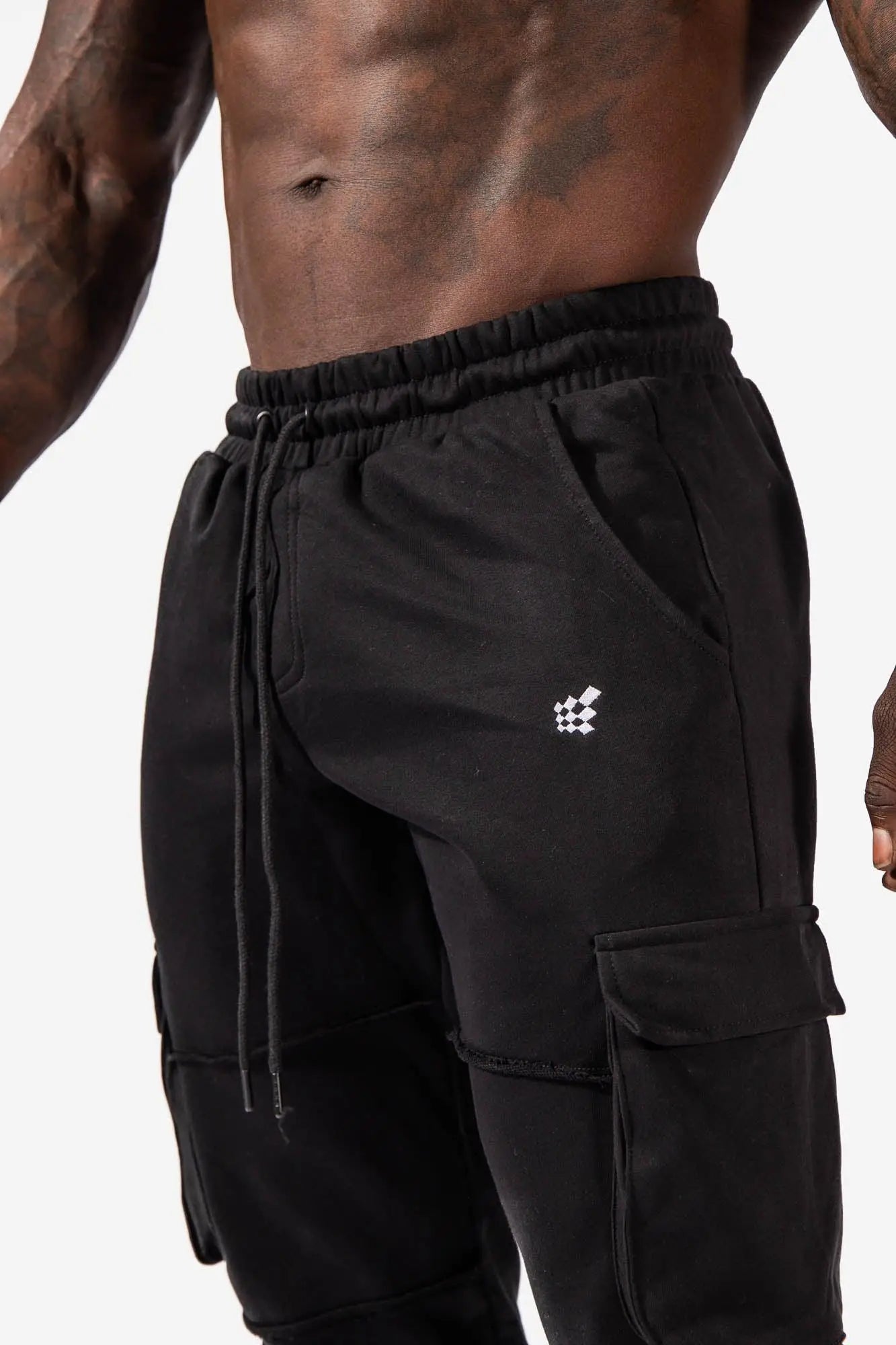 Black renegade cargo joggers with drawstring waistband and white geometric logo on the thigh for casual wear