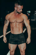 Black retro bodybuilding shorts with a fitted form-fitting design ideal for athletic workouts and training