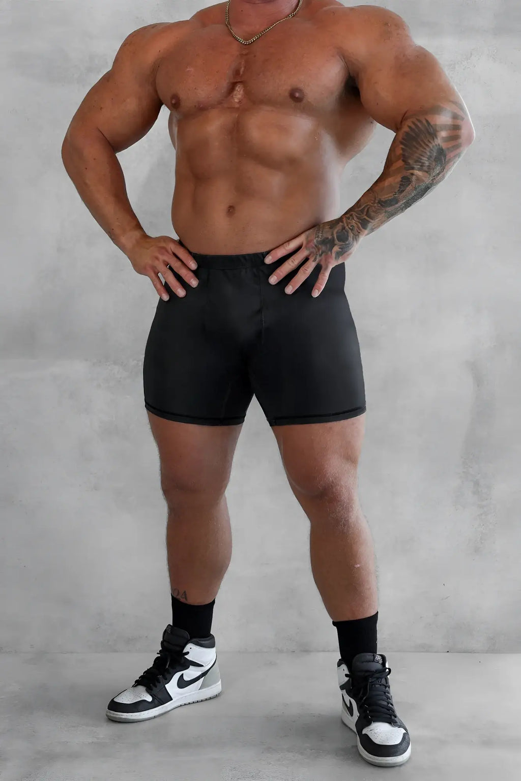 Black snug fit retro bodybuilding shorts with elastic waistband ideal for athletic use