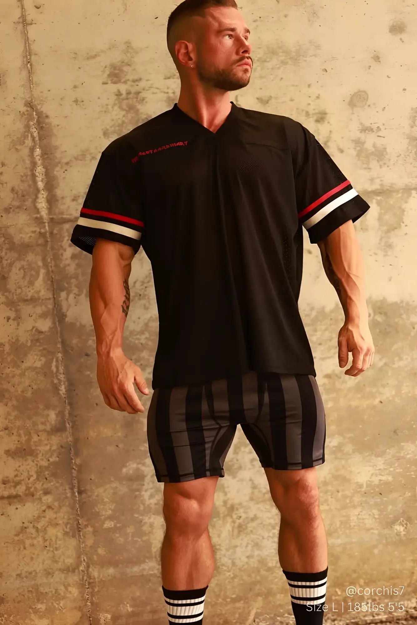 Black athletic shirt with red and white striped sleeves and v neck design featured with retro bodybuilding shorts black gray