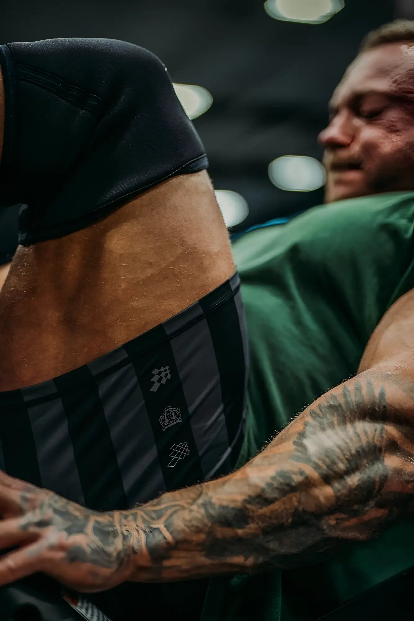 Retro bodybuilding shorts in black and gray with black and gray stripes and a subtle logo pattern on the side