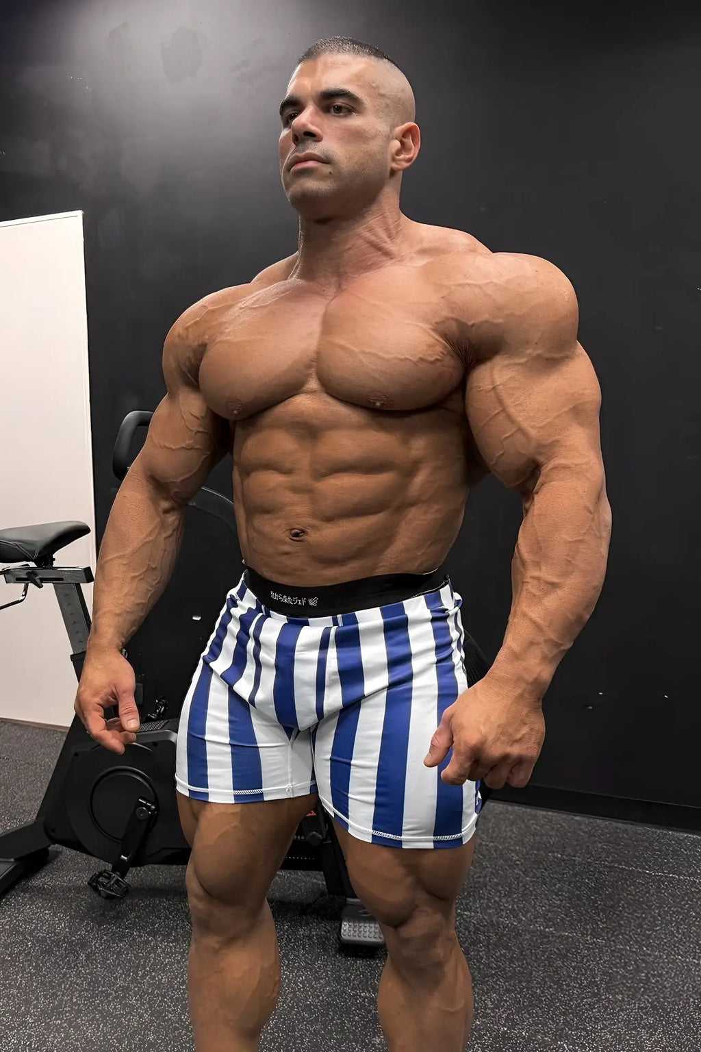Retro bodybuilding shorts feature blue and white stripes with a black waistband for athletic use