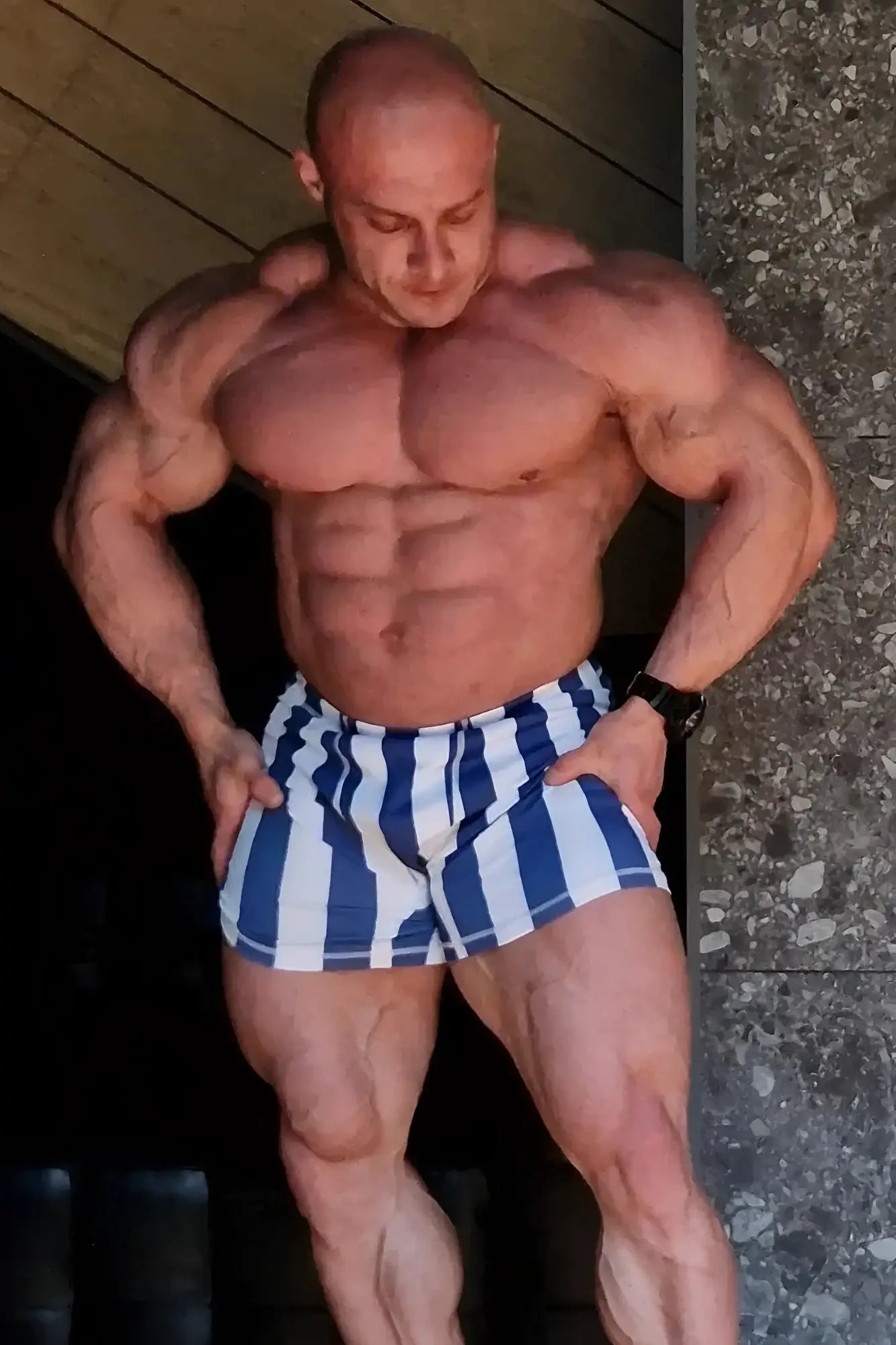 Retro bodybuilding shorts in blue and white striped athletic fabric designed for comfortable workout wear