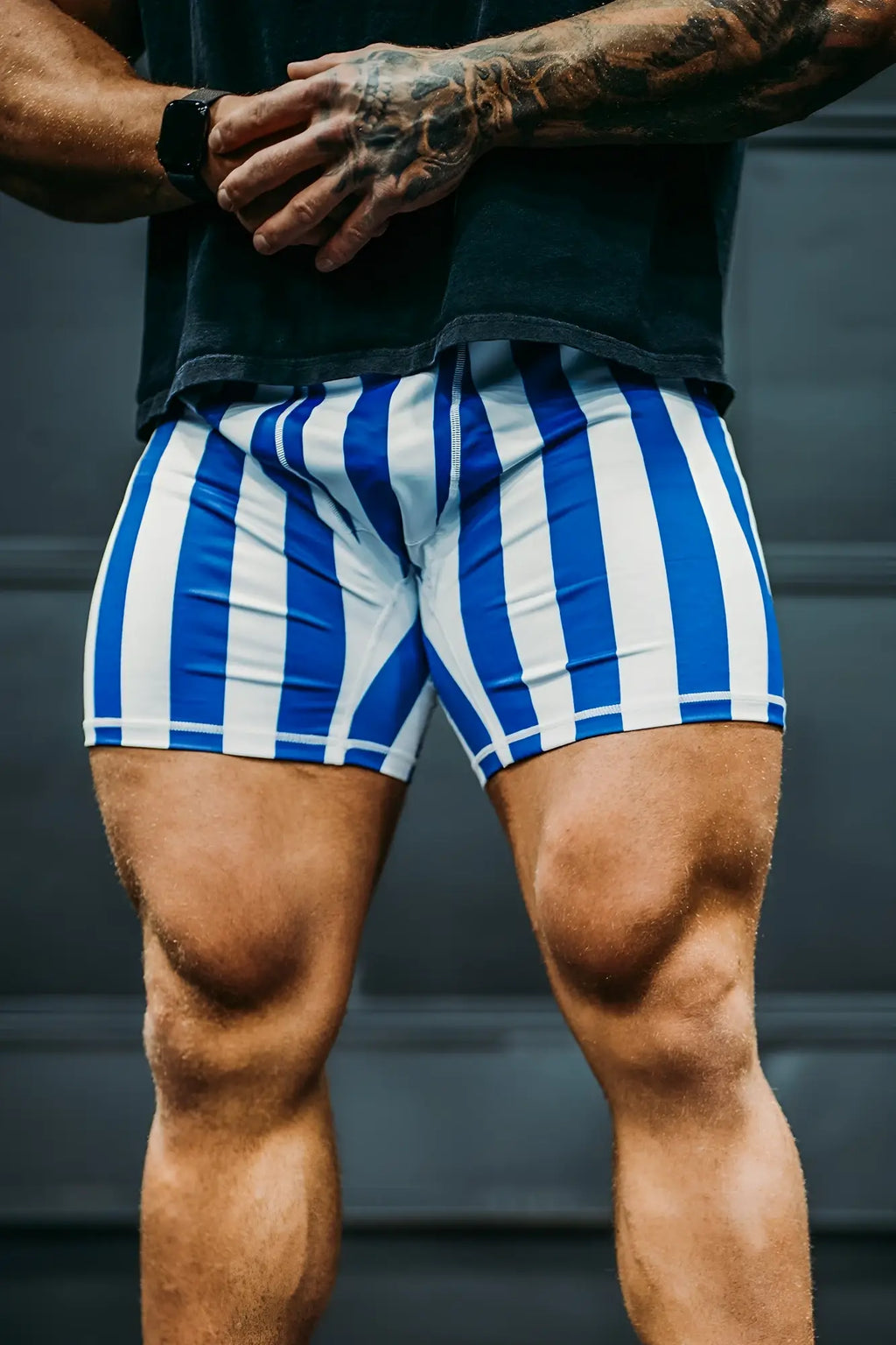 Retro bodybuilding shorts with blue and white vertical stripes designed for athletic use in lightweight fabric