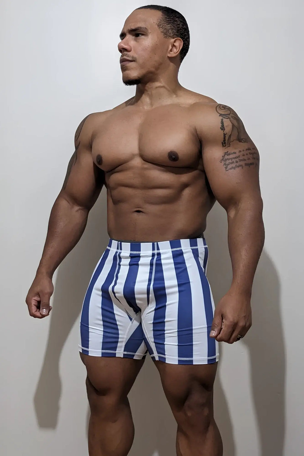 Retro bodybuilding shorts in blue and white vertical stripes made from athletic fabric for performance use