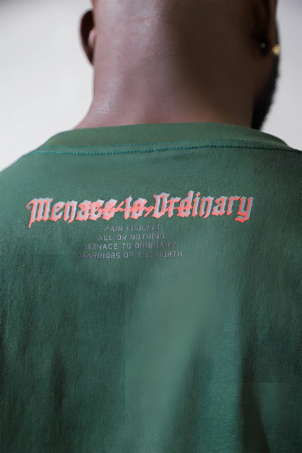 Back of a dark green cotton jed north retro gym long sleeve t shirt with orange embroidered text mensseeasordinary