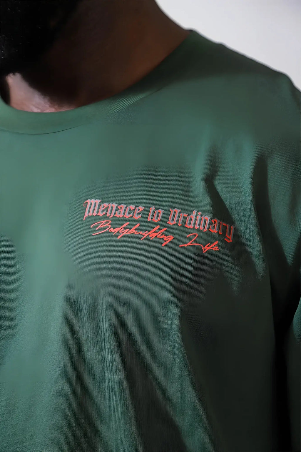 Jed North retro gym long sleeve cotton t-shirt in army green with red embroidered menace to ordinary and babysitting life text