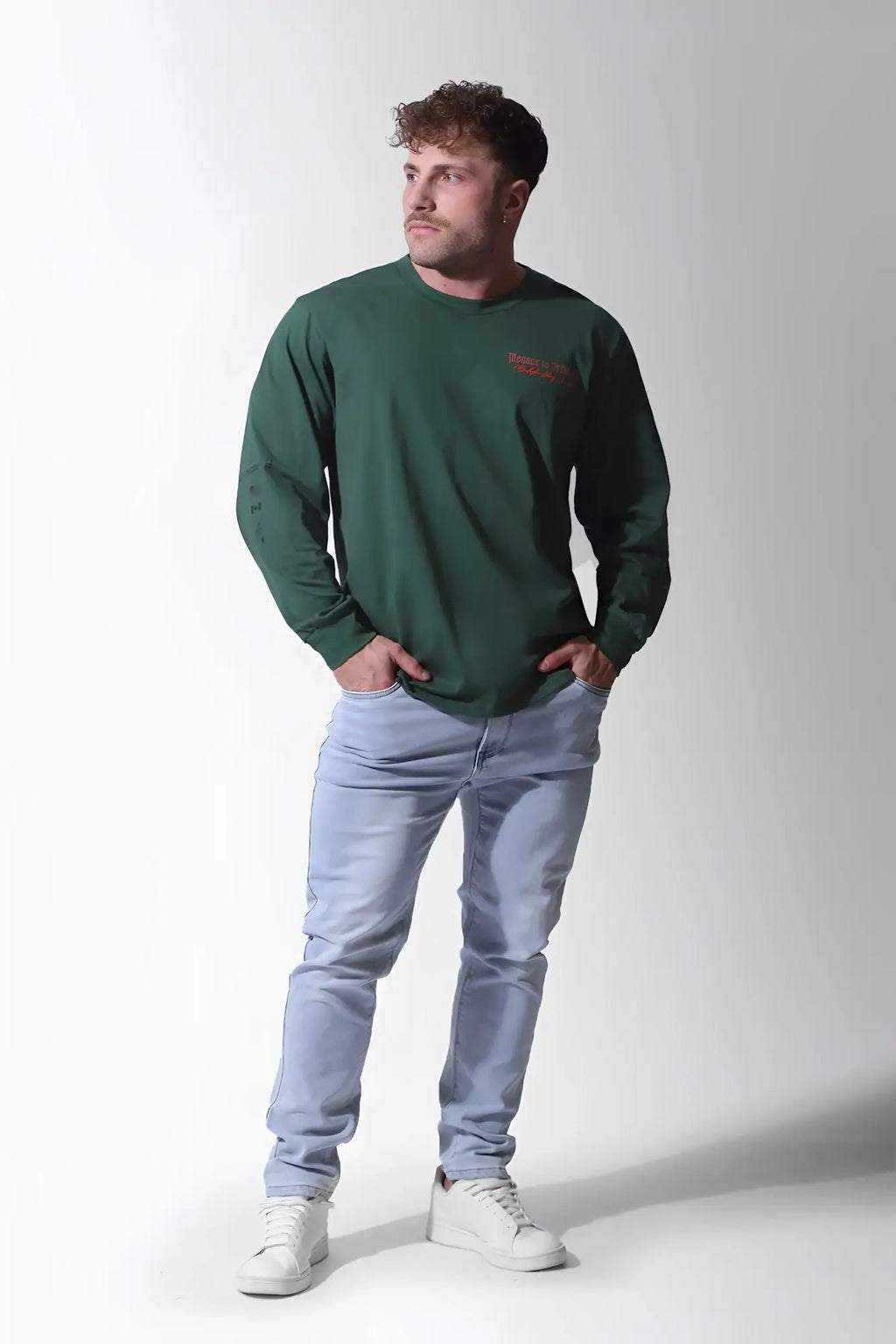 Dark green long-sleeved crewneck t-shirt with small red logo on left chest by jed north in army green